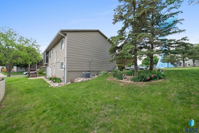 4401 E 28th St, Sioux Falls, SD 57103 - view of side of home with central air condition unit and a yard
