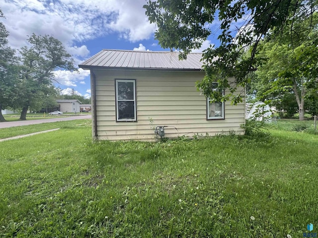 203 Dunham St, Valley Springs, SD 57068 - view of home's exterior featuring metal roof and a lawn