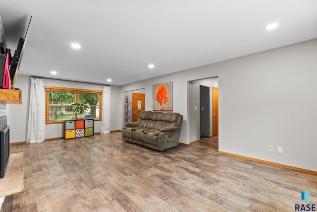4804 W 39th St, Sioux Falls, SD 57106 - living room featuring a brick fireplace, light wood finished floors, recessed lighting, and baseboards