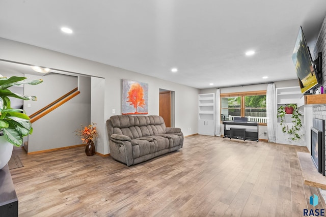 4804 W 39th St, Sioux Falls, SD 57106 - living room featuring a fireplace, light wood-style flooring, recessed lighting, and baseboards