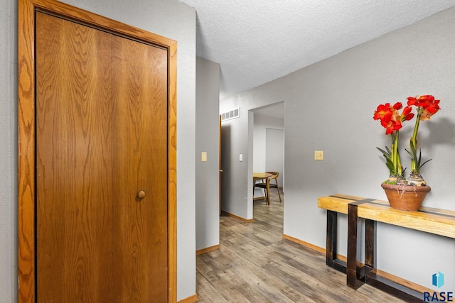 4804 W 39th St, Sioux Falls, SD 57106 - hall with light wood-style flooring, baseboards, and a textured ceiling
