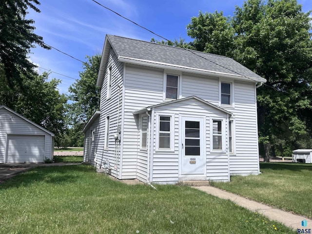 1300 E Prospect St, Sioux Falls, SD 57104 - view of front of house with an outdoor structure, a garage, a front yard, and roof with shingles