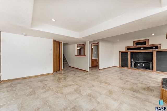 201 N Foss Ave, Sioux Falls, SD 57110 - unfurnished living room with baseboards, stairway, recessed lighting, and stone finish floors