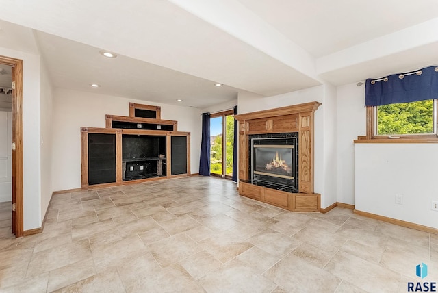 201 N Foss Ave, Sioux Falls, SD 57110 - unfurnished living room featuring a fireplace, baseboards, healthy amount of natural light, and recessed lighting