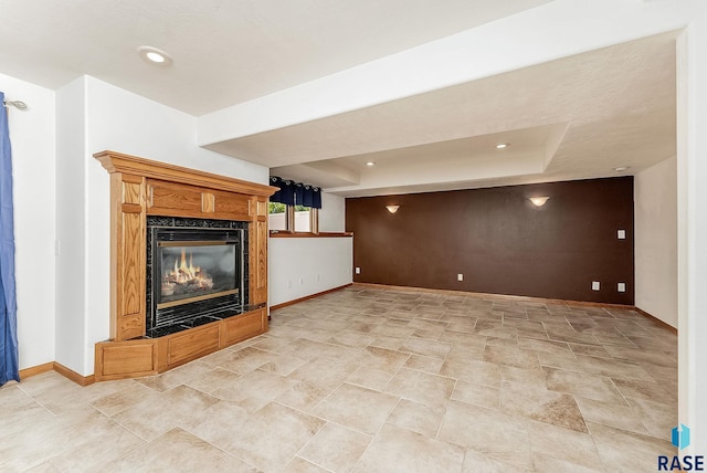 201 N Foss Ave, Sioux Falls, SD 57110 - unfurnished living room with baseboards, a fireplace, a tray ceiling, and recessed lighting
