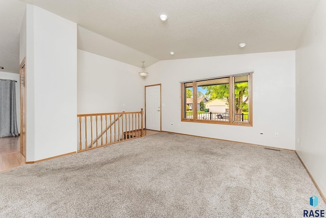 201 N Foss Ave, Sioux Falls, SD 57110 - carpeted spare room with lofted ceiling, baseboards, and a textured ceiling