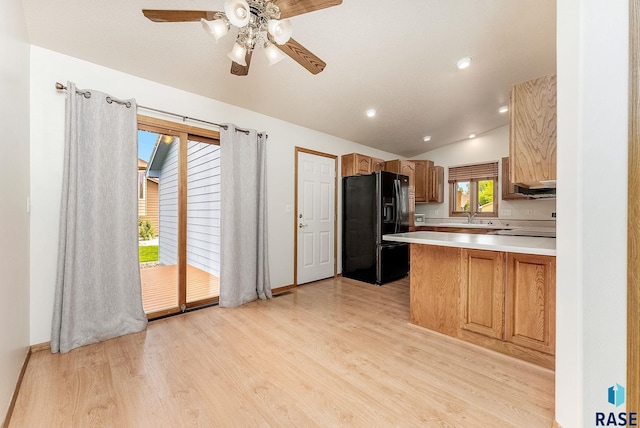 201 N Foss Ave, Sioux Falls, SD 57110 - kitchen featuring black fridge, vaulted ceiling, light wood finished floors, a ceiling fan, and light countertops