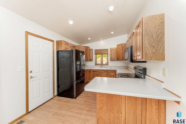 201 N Foss Ave, Sioux Falls, SD 57110 - kitchen featuring fridge with ice dispenser, range with electric cooktop, a sink, a peninsula, and vaulted ceiling