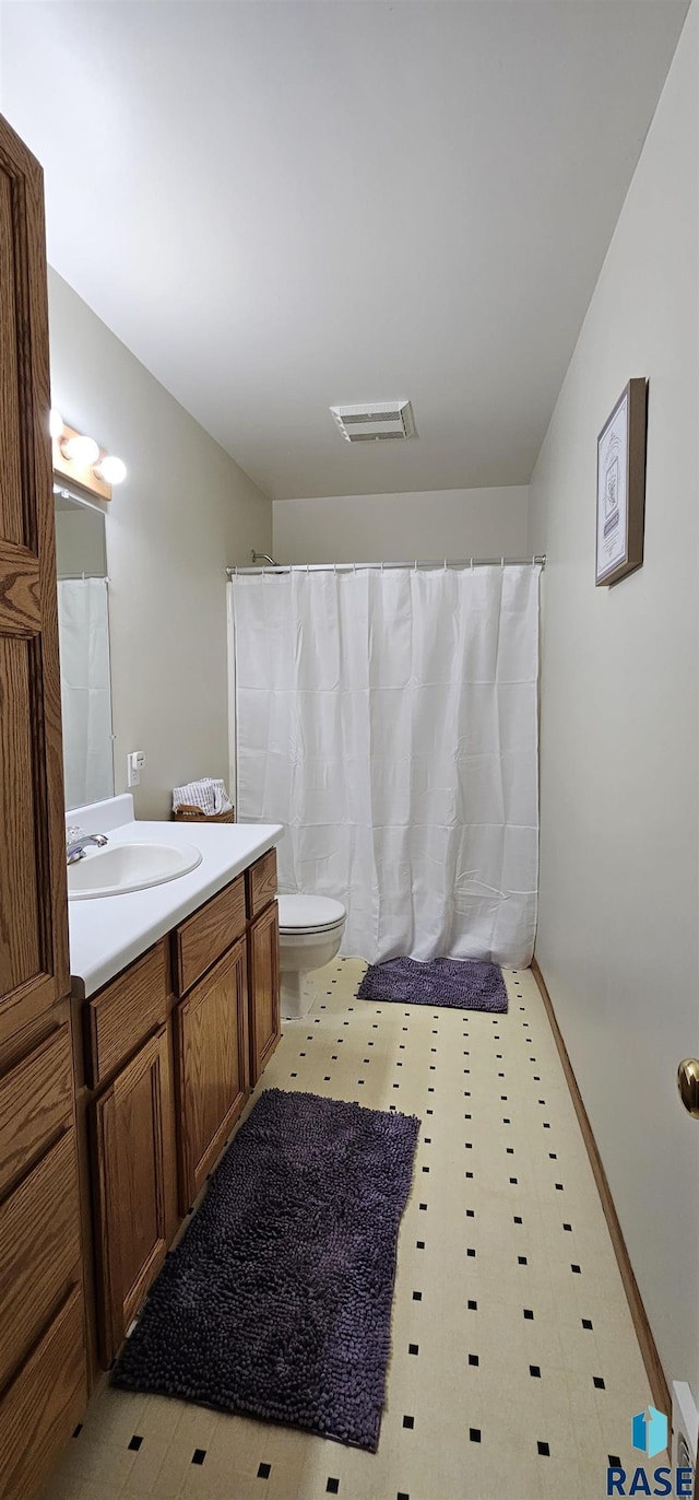 2904 S Glendale Ave, Sioux Falls, SD 57105 - bathroom with toilet, vanity, tile patterned floors, and a shower with shower curtain