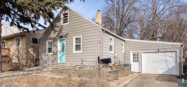 316 S Sherman Ave, Sioux Falls, SD 57103 - view of front of property featuring a chimney, a garage, central air condition unit, and driveway