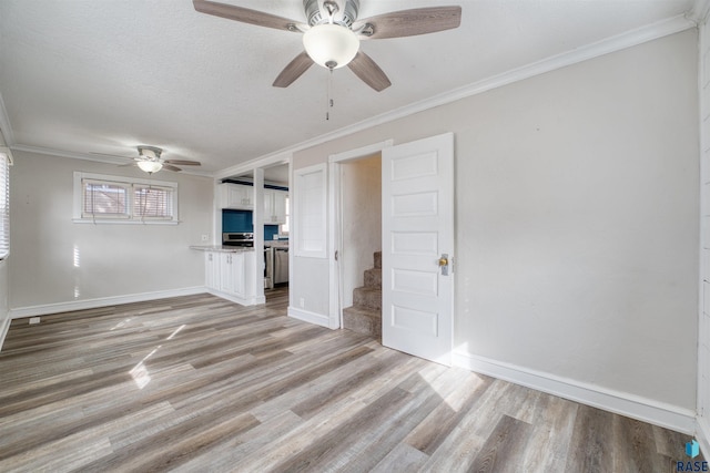 316 S Sherman Ave, Sioux Falls, SD 57103 - unfurnished living room with ceiling fan, light wood-style flooring, stairs, ornamental molding, and baseboards