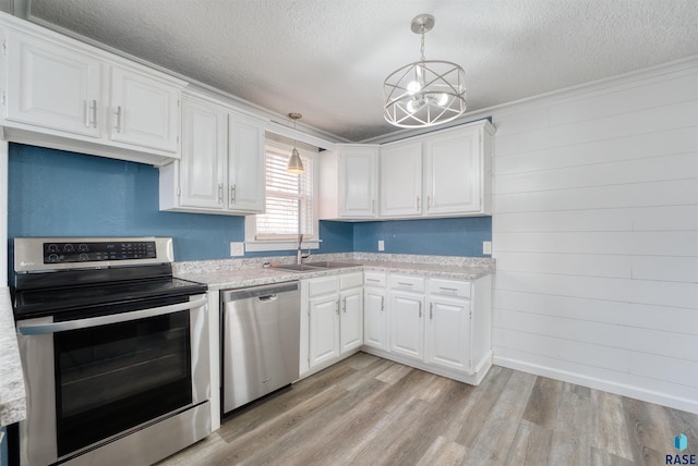 316 S Sherman Ave, Sioux Falls, SD 57103 - kitchen with stainless steel appliances, a sink, a textured ceiling, light wood finished floors, and white cabinetry