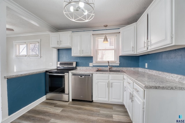 316 S Sherman Ave, Sioux Falls, SD 57103 - kitchen featuring appliances with stainless steel finishes, a sink, a textured ceiling, ornamental molding, and white cabinetry