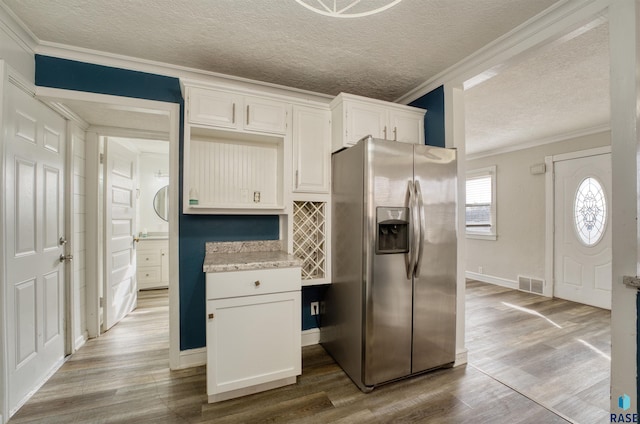 316 S Sherman Ave, Sioux Falls, SD 57103 - kitchen featuring stainless steel refrigerator with ice dispenser, wood finished floors, a textured ceiling, ornamental molding, and baseboards