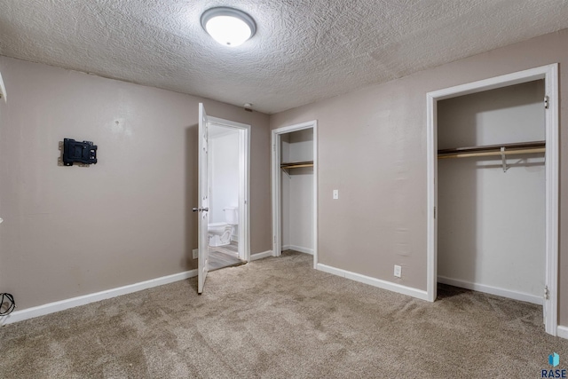 316 S Sherman Ave, Sioux Falls, SD 57103 - unfurnished bedroom featuring carpet, two closets, a textured ceiling, and baseboards