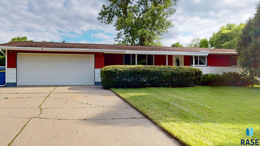 1024 Orchard Dr, Brookings, SD 57006 - single story home with a front lawn, a garage, and concrete driveway