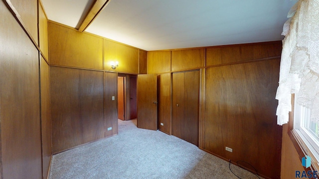 1024 Orchard Dr, Brookings, SD 57006 - unfurnished bedroom featuring carpet floors and wood walls