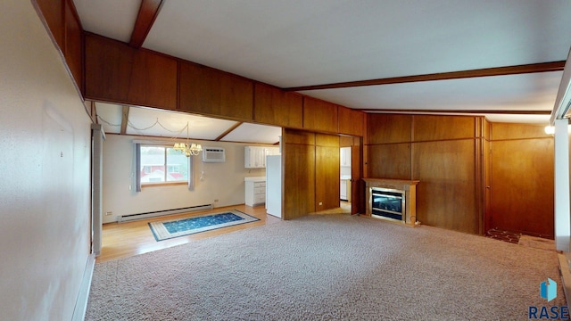 1024 Orchard Dr, Brookings, SD 57006 - unfurnished living room with a baseboard radiator, a wall mounted AC, a chandelier, carpet flooring, and a glass covered fireplace