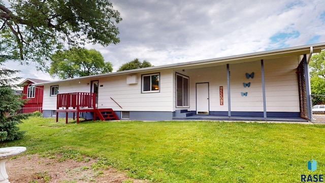 1024 Orchard Dr, Brookings, SD 57006 - back of property with a lawn and a wooden deck
