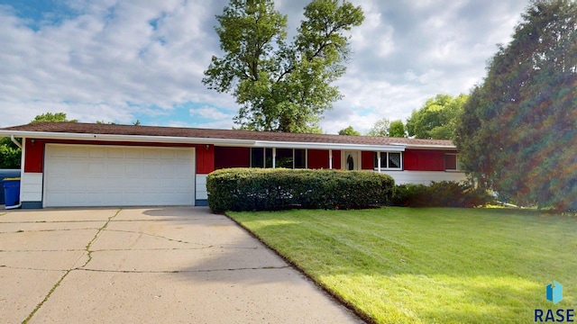 1024 Orchard Dr, Brookings, SD 57006 - ranch-style home featuring concrete driveway, a garage, and a front lawn