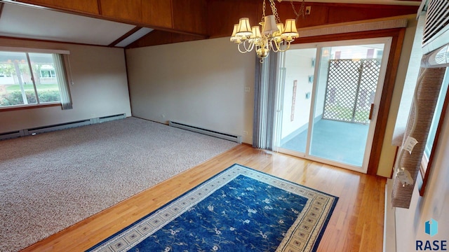 1024 Orchard Dr, Brookings, SD 57006 - unfurnished room featuring baseboard heating, a chandelier, wood finished floors, and a baseboard radiator
