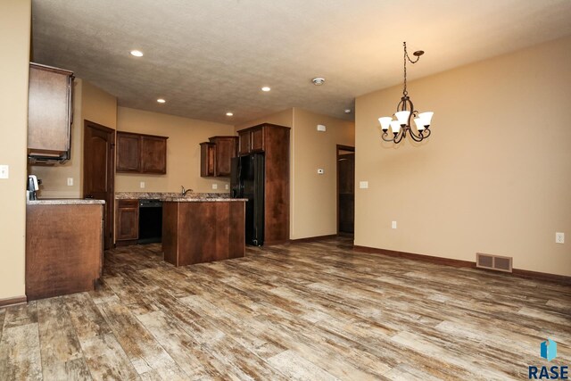 6400 S Keller Cir, Sioux Falls, SD 57108 - kitchen featuring a center island, black appliances, wood finished floors, a chandelier, and recessed lighting