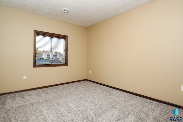 6400 S Keller Cir, Sioux Falls, SD 57108 - carpeted spare room featuring baseboards and a smoke detector