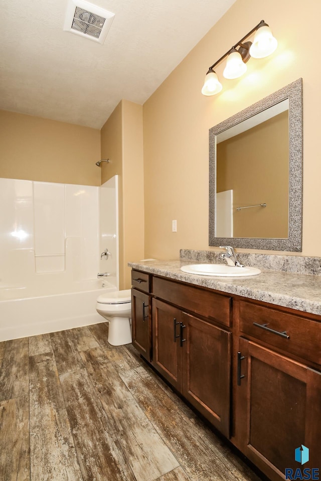 6400 S Keller Cir, Sioux Falls, SD 57108 - full bath featuring wood finished floors, vanity, shower / bath combination, and toilet