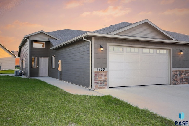 6400 S Keller Cir, Sioux Falls, SD 57108 - ranch-style home featuring an attached garage, central AC unit, concrete driveway, a front lawn, and a shingled roof