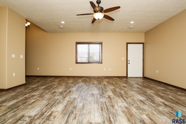 6400 S Keller Cir, Sioux Falls, SD 57108 - spare room featuring wood finished floors, a ceiling fan, baseboards, and recessed lighting