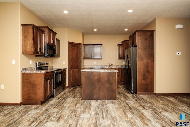 6400 S Keller Cir, Sioux Falls, SD 57108 - kitchen with stainless steel appliances, a kitchen island, wood finished floors, recessed lighting, and baseboards