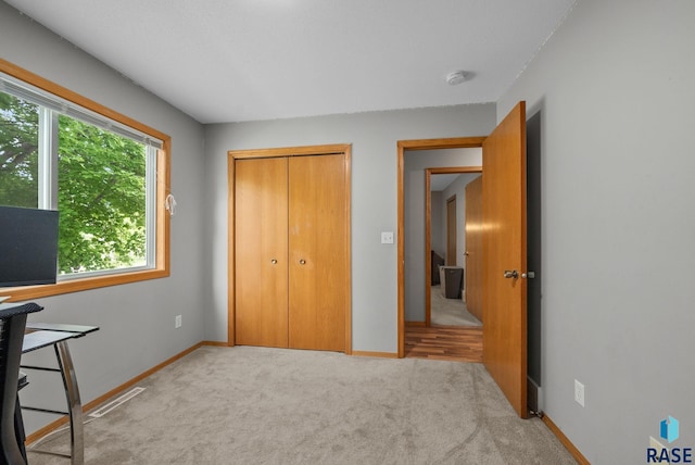 800 N Poplar Ave, Tea, SD 57064 - unfurnished bedroom featuring carpet flooring, a closet, and baseboards