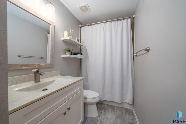800 N Poplar Ave, Tea, SD 57064 - full bathroom with wood finished floors, vanity, toilet, and a shower with shower curtain