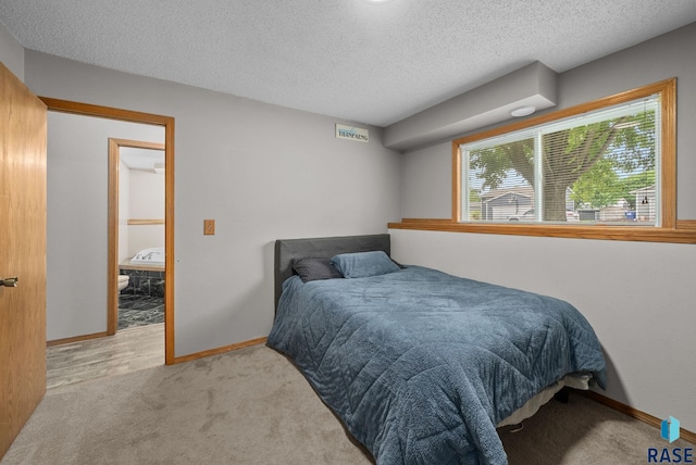 800 N Poplar Ave, Tea, SD 57064 - bedroom with light carpet, a textured ceiling, and baseboards