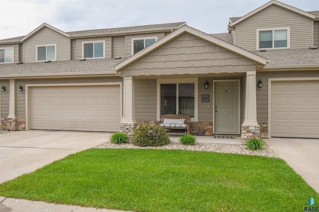 5411 S Ledgestone Pl, Sioux Falls, SD 57108 - multi unit property with a porch, concrete driveway, stone siding, and a front yard
