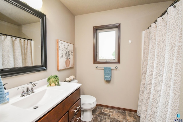 5411 S Ledgestone Pl, Sioux Falls, SD 57108 - full bath featuring baseboards, vanity, toilet, stone finish floors, and a shower with curtain