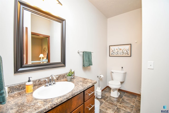 5411 S Ledgestone Pl, Sioux Falls, SD 57108 - bathroom with baseboards, vanity, and toilet