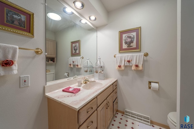 200 Best Point Dr, Madison, SD 57042 - half bathroom featuring toilet, vanity, tile patterned floors, and baseboards