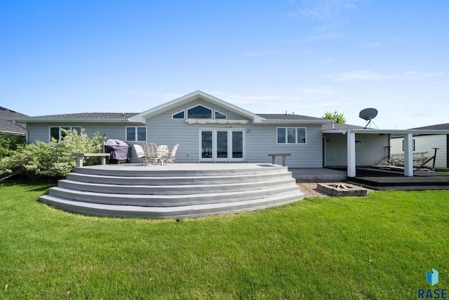 200 Best Point Dr, Madison, SD 57042 - back of property with a wooden deck, a yard, and a shingled roof