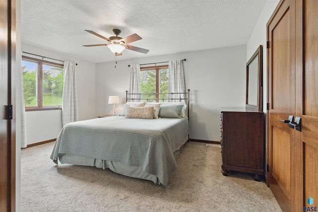 26646 461st Ave, Hartford, SD 57033 - bedroom with light carpet, a textured ceiling, a ceiling fan, and baseboards