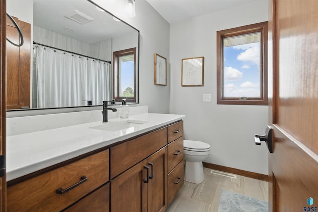 26646 461st Ave, Hartford, SD 57033 - full bathroom featuring vanity, toilet, baseboards, and a shower with shower curtain