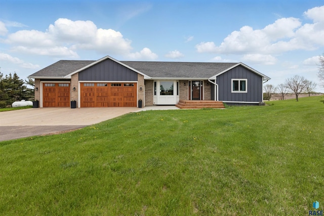 26646 461st Ave, Hartford, SD 57033 - view of front of house with board and batten siding, a front lawn, an attached garage, driveway, and brick siding