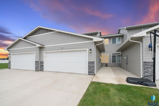 9054 W Ark Pl, Sioux Falls, SD 57106 - multi unit property with stone siding, driveway, and a garage