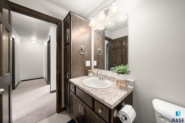 9054 W Ark Pl, Sioux Falls, SD 57106 - bathroom with vanity, toilet, and baseboards