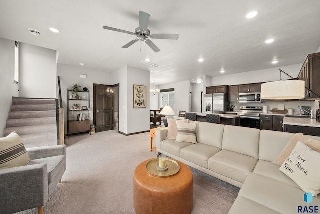 9054 W Ark Pl, Sioux Falls, SD 57106 - living room featuring light colored carpet, recessed lighting, stairs, ceiling fan, and baseboards