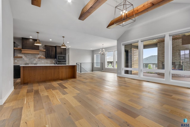 7324 E Twin Pines Ct, Sioux Falls, SD 57110 - kitchen featuring a chandelier, open floor plan, built in microwave, light countertops, and recessed lighting