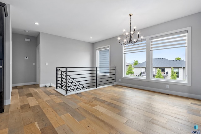 7324 E Twin Pines Ct, Sioux Falls, SD 57110 - spare room with a chandelier, light wood-type flooring, baseboards, and recessed lighting