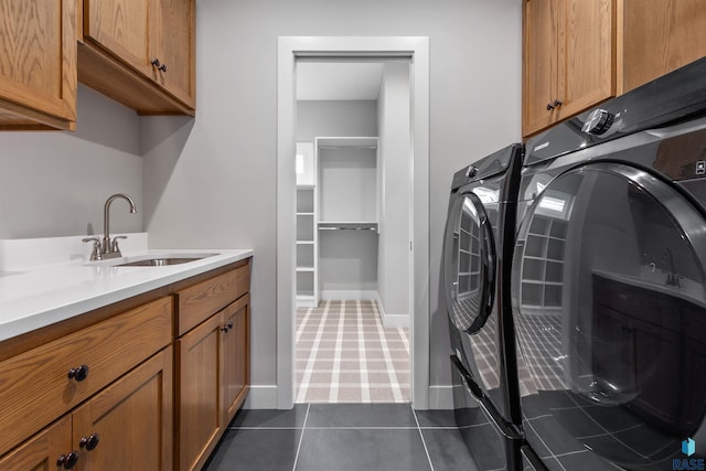 7324 E Twin Pines Ct, Sioux Falls, SD 57110 - laundry room featuring washing machine and dryer, cabinet space, baseboards, dark carpet, and dark tile patterned floors