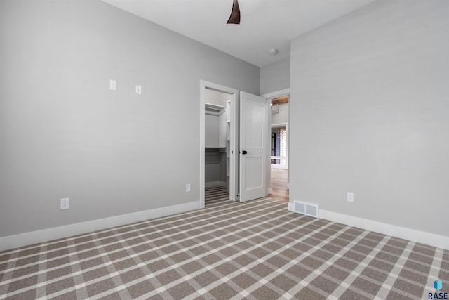 7324 E Twin Pines Ct, Sioux Falls, SD 57110 - unfurnished bedroom with carpet flooring, a spacious closet, a closet, baseboards, and a ceiling fan