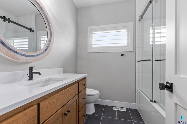 7324 E Twin Pines Ct, Sioux Falls, SD 57110 - full bathroom with vanity, toilet, tile patterned flooring, combined bath / shower with glass door, and baseboards